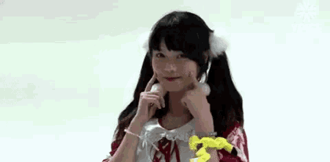 a young woman is making a funny face with her hands .
