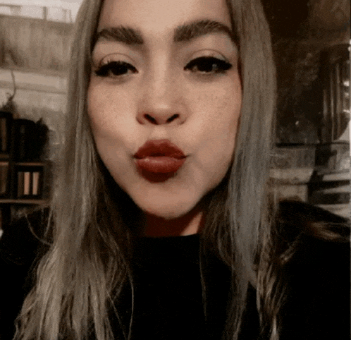a close up of a woman 's face with her lips closed