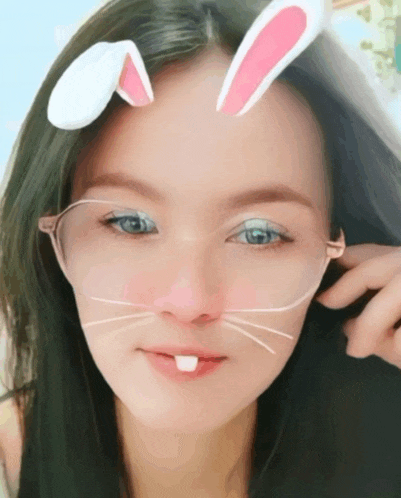 a woman with bunny ears on her forehead looks at the camera