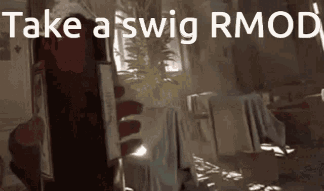 a person holding a bottle with the words take a swig rmod on it