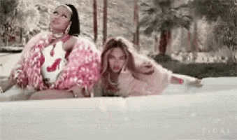 a couple of women are sitting in a bathtub together .