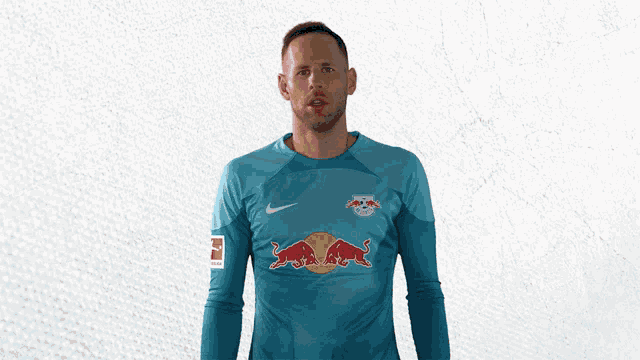 a man is wearing a blue shirt with red bulls on it