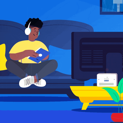 a man is sitting on a couch with headphones on while playing a game