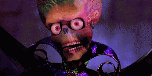 a colorful skeleton with big red eyes and a purple necklace