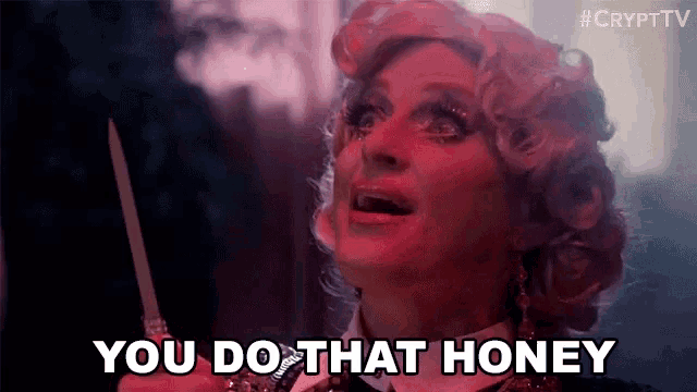 a woman in a red wig is holding a knife and saying you do that honey