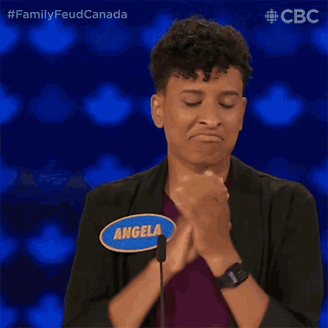 a woman with a name tag that says angel is clapping