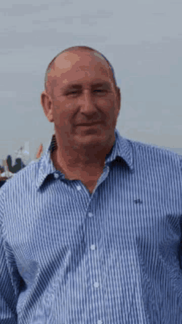a man wearing a blue and white striped shirt