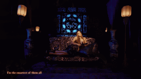 a close up of a woman with long hair in a dark room .