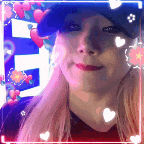 a close up of a woman 's face with hearts and flowers around it