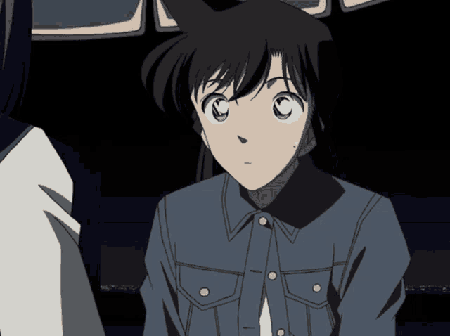 a girl in a blue denim jacket has a c on her forehead