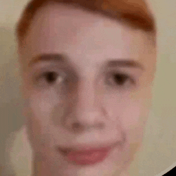a close up of a young man 's face with red hair .