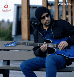 a man is sitting on a bench playing a blue electric guitar