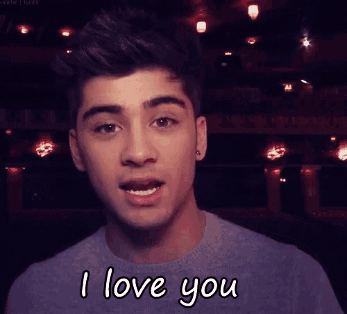 a young man says " i love you " in front of a dark room