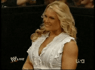 a woman in a white ruffled top is smiling in front of a screen that says usa live