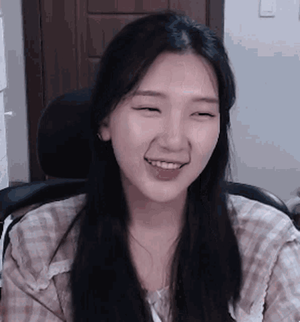 a woman is smiling with her eyes closed and her tongue sticking out