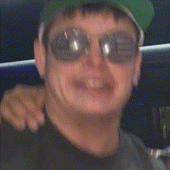 a man wearing sunglasses and a hat with a ny on it