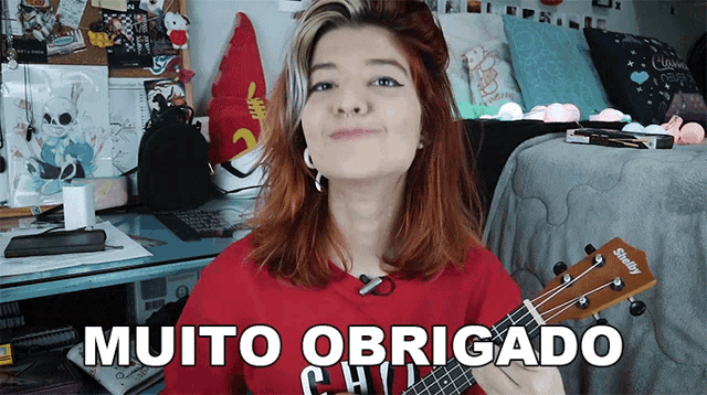 a girl holding a guitar with the words muito obrigado in the corner