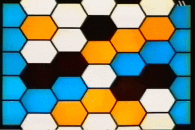 a stained glass window with blue and orange hexagons on it