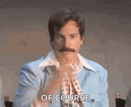 a man with a mustache is sitting at a table with his hands folded in front of his face and says `` of course '' .