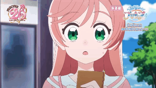 a girl with pink hair and green eyes holds a notebook