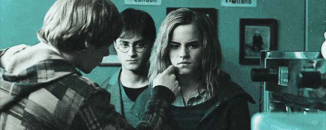 harry potter and hermione granger are standing next to each other in front of a sign that says london