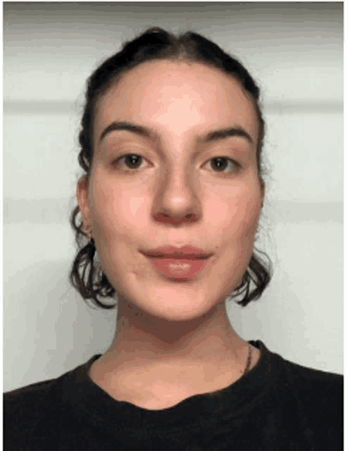 a woman with short hair is wearing a black shirt