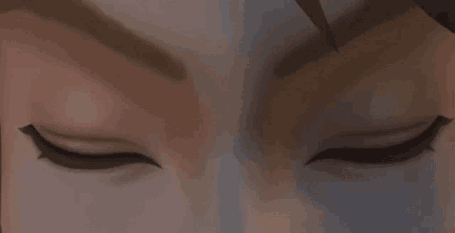 a close up of a person 's blue eyes with a brown background