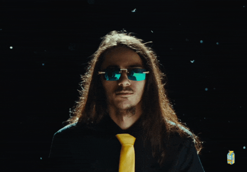 a man with long hair is wearing sunglasses and a black shirt