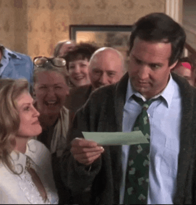 a man in a green tie is holding a piece of paper in front of a group of people