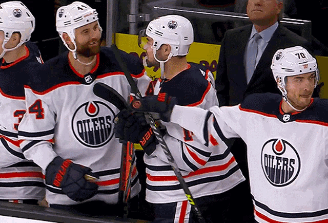 a group of edmonton oilers hockey players are standing on the ice