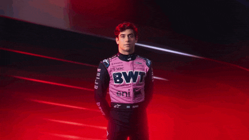 a man with red hair is wearing a pink shirt with bv colapinto written on it