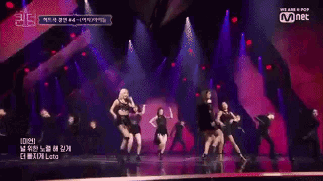 a group of women are dancing on a stage with a sign that says we are k pop