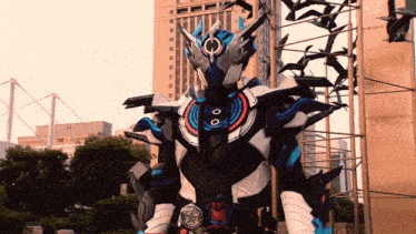 a man in a robot costume stands in front of a sculpture