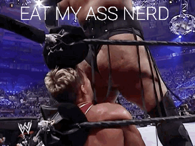 a man in a wrestling ring with the words eat my ass nerd on the bottom