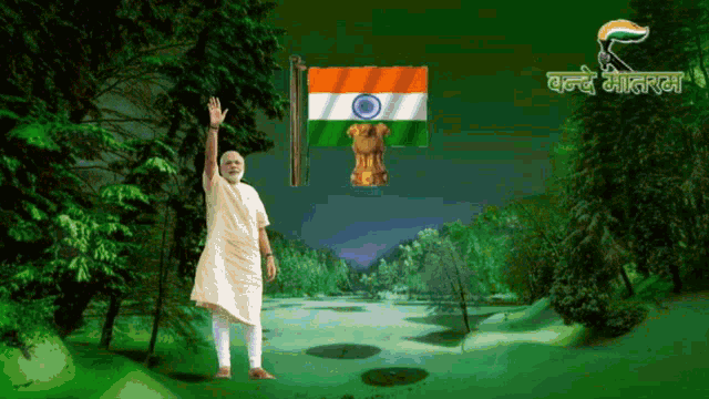 a man stands in front of a flag and a sign that says ' vande matram ' on it