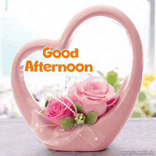 a pink heart shaped vase with pink roses and the words good afternoon written on it
