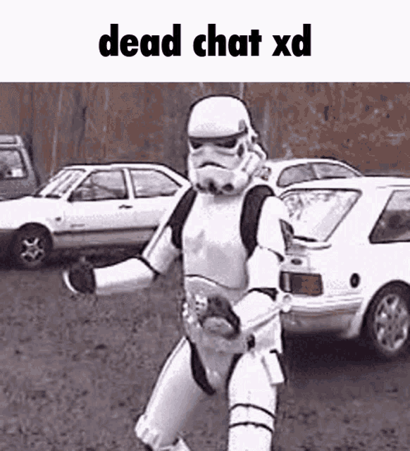 a storm trooper is standing in front of a parking lot with cars .