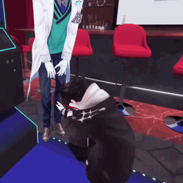 a man in a white coat is kneeling down next to another man in a black hoodie