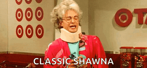 a woman wearing a neck brace and a pink jacket is holding a lollipop .