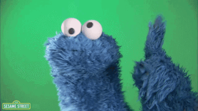 a cookie monster from sesame street on a green background