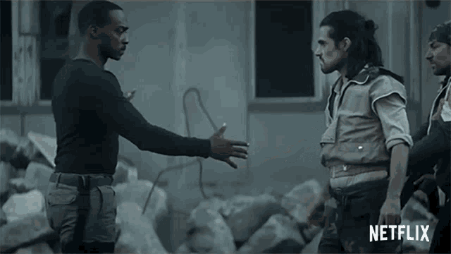 a man shaking hands with another man with a netflix logo in the corner