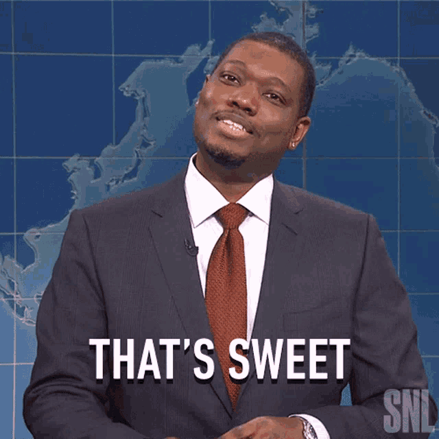 a man in a suit and tie says that 's sweet in front of a map