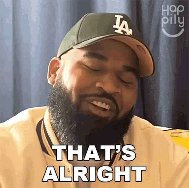 a man with a beard is wearing a la hat and says that 's alright