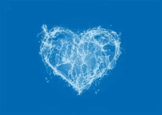 a heart made out of water on a blue background .