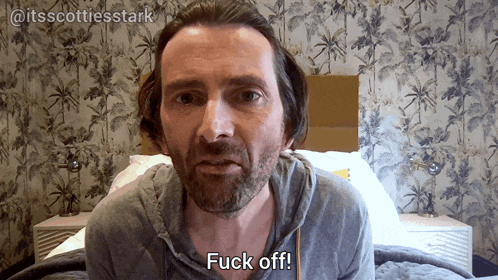 a man with a beard is saying fuck off