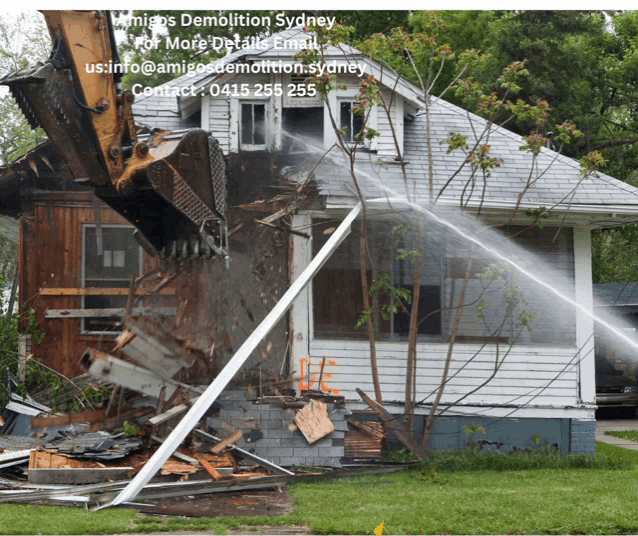 a white house is being demolished by a bulldozer with a website for amigos demolition sydney
