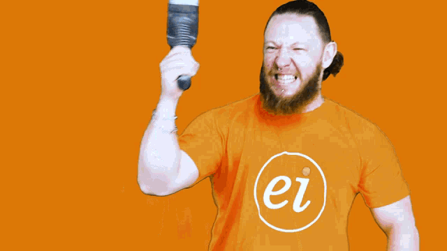 a man in an orange shirt with the letter ei on it holds a hammer