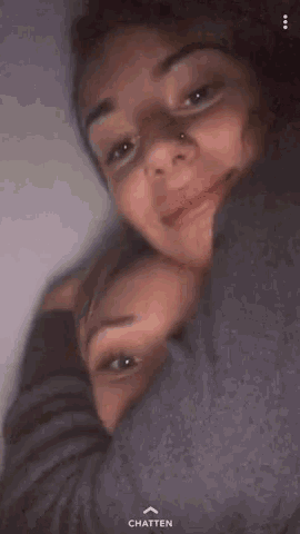 two girls are hugging each other and the chatten button is on the bottom left