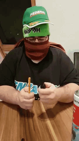 a person wearing a green hat that says federal