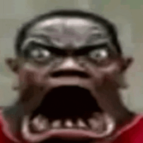a close up of a man 's face with a very angry look on it .